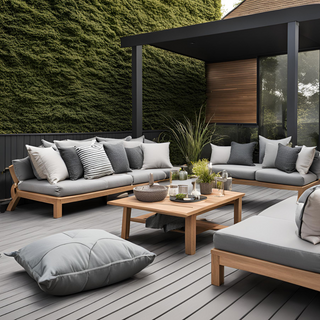 Outdoor furniture set on a grey composite deck with scatter cushions and refreshments on the table with patio doors at the back